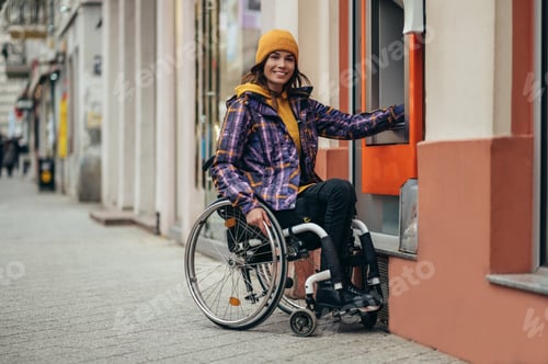 Preview: Woman with disability using credit card and atm machine
