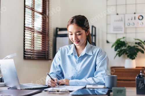Preview: Smiling Woman Working at Desk in Bright Home