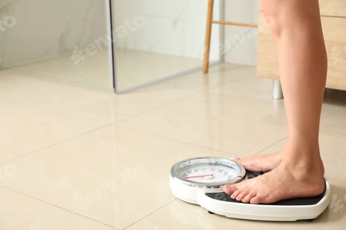 Preview: Woman standing on scales in bathroom, space for text. Overweight problem