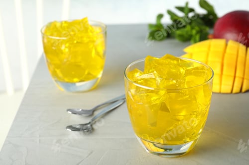Preview: Composition with mango jelly in glass on table. Space for text