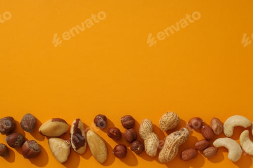 Preview: Assortment of different nuts on an orange background