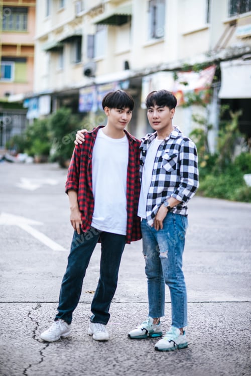 Preview: Two loving young men in shirts and standing on the street.