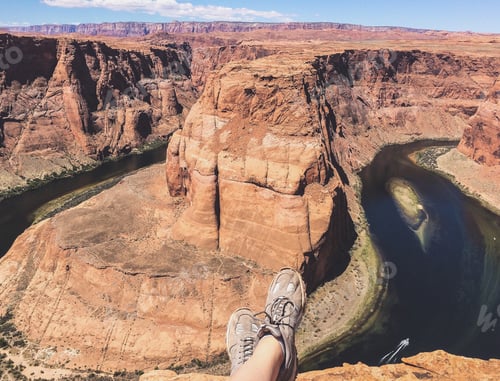 Preview: A hiker resting at the rock overlooking the Horseshoe Bend, Arizona, the USA