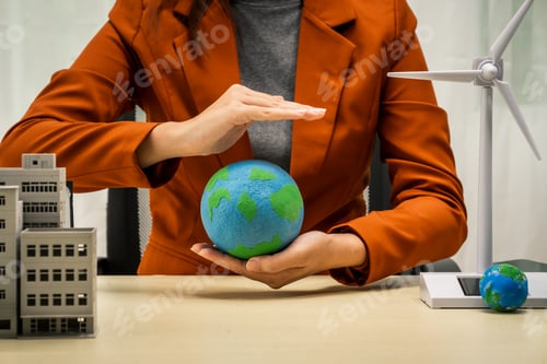 Preview: A businesswoman working at a desk in sustainable urban development, promoting eco-friendly