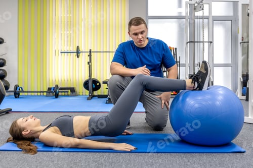 Preview: Woman Working Out with Trainer at Gym