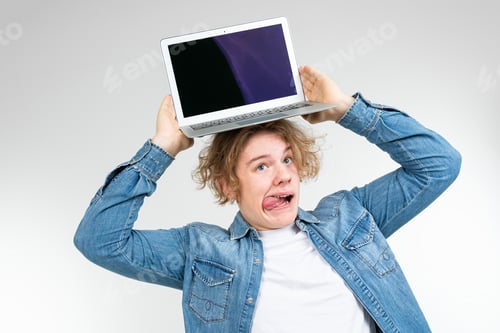 Preview: contented cool blond man holding a laptop with a layout for inserting a page on a white background