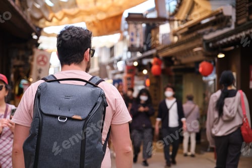 Preview: European tourist visiting a traditional street in Miyajima, Hiroshima, Japan.