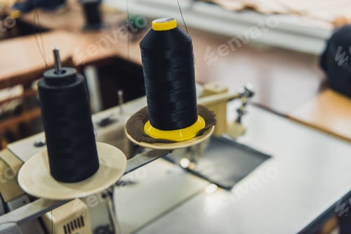 Preview: selective focus of black sewing strings at tailor workshop
