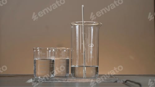 Preview: Male researcher carrying out scientific research in a lab. Flasks with liquids in a lab. Liquid in