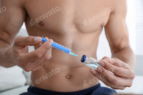 Preview: Man filling syringe with drug, closeup. Doping concept