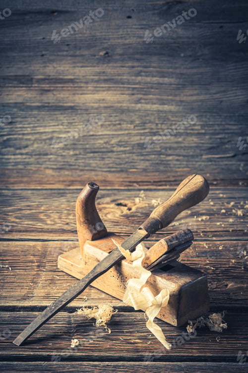 Preview: Closeup of rustic chisel and planer in a carpentry workshop