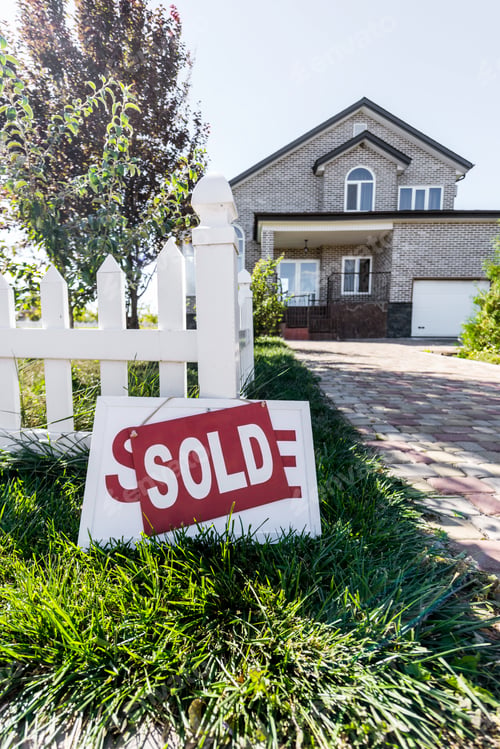 Preview: beautiful new house with sign sold leaning on fence