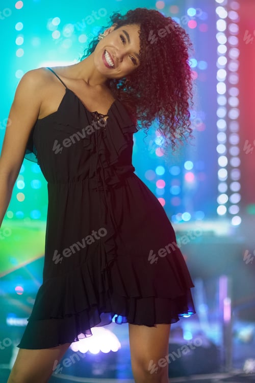 Preview: Moving to the music. Shot of a beautiful young woman dancing in a nightclub.