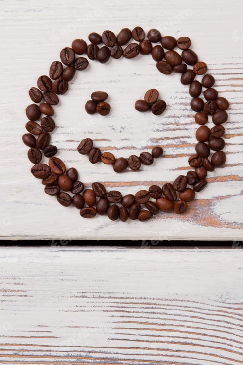 Preview: Coffee beans arranged in a smiling face.