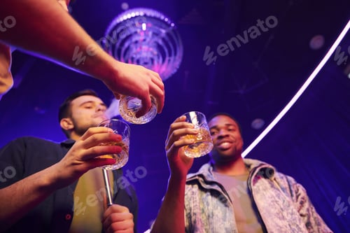 Preview: View from below. Group of friends having fun in the night club together