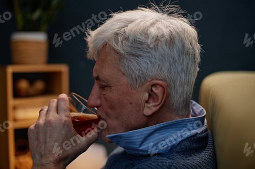 Preview: Senior Man Sipping Drink in Relaxed Ambiance