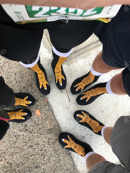 Preview: A family is getting ready for a turkey trot and puts on their turkey socks.