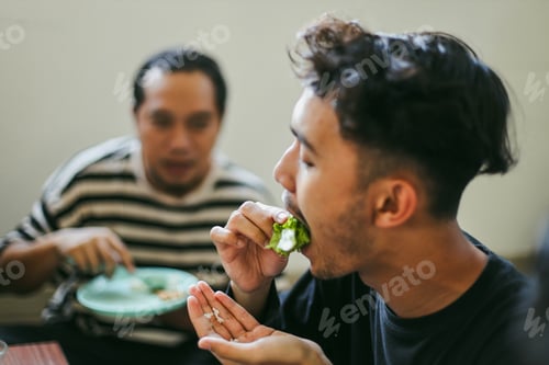 Preview: Portrait Of Young Man Enjoying Eat Korean Barbeque Together With Friends