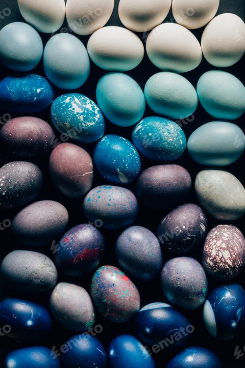 Preview: top view of colored painted easter eggs on dark table