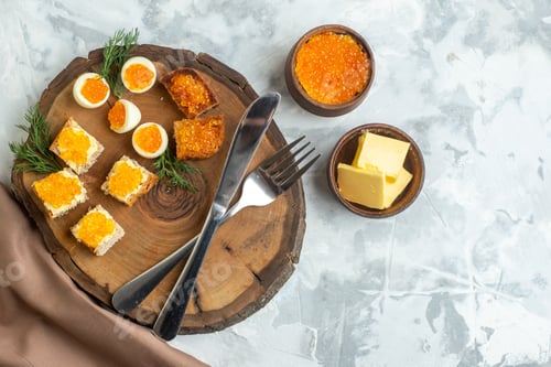 Preview: top view tasty caviar sandwiches with boiled eggs and cutlery on wooden board white background