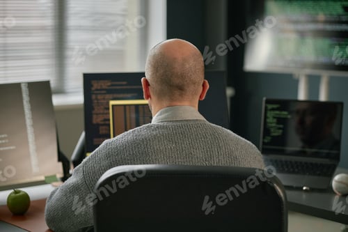 Preview: Middle Aged Caucasian Man Working on Computer Monitors in Modern Office