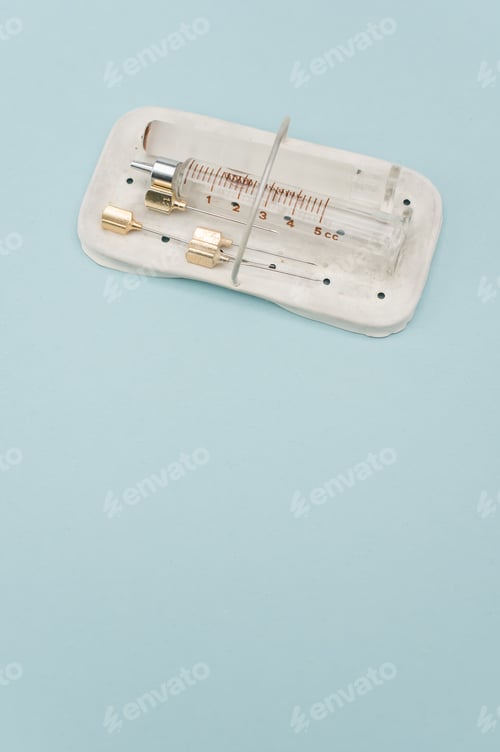 Preview: isolated sterilized glass injection syringe in a box on a blue background