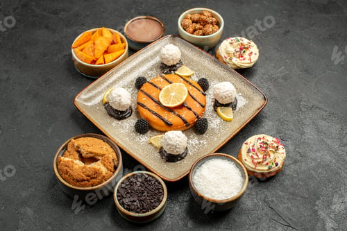 Preview: front view delicious little cake with coconut candies on dark-grey background cake dessert biscuit
