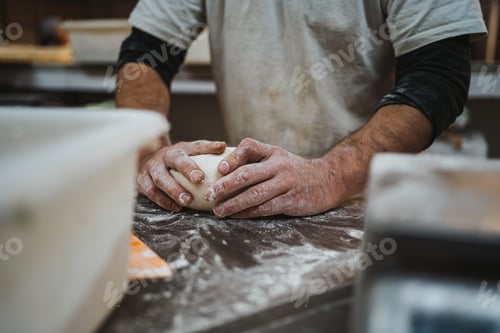 Preview: Baker kneading bread dough