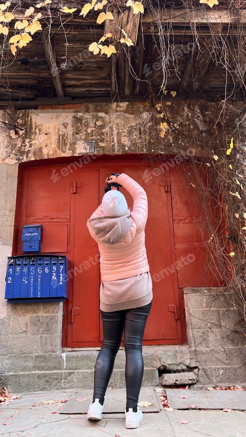 Preview: Woman Taking Pictures of an Old Building Facade