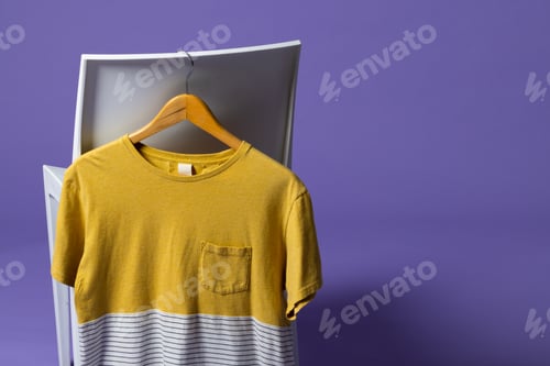 Preview: Tshirt displayed on chair and copy space on purple background