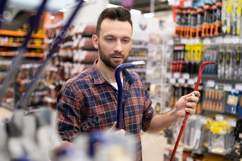 Preview: a young man in a hardware store chooses a nail puller