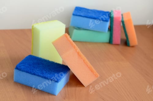 Preview: A few kitchen sponges lie on a wooden kitchen countertop