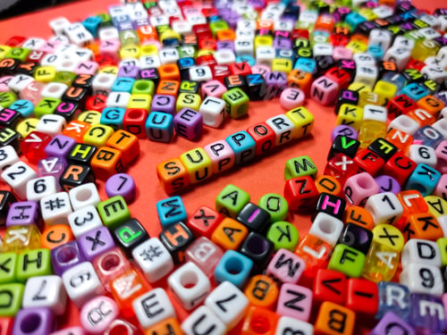 Preview: Selective focus.Colorful dice with word SUPPORT on red background