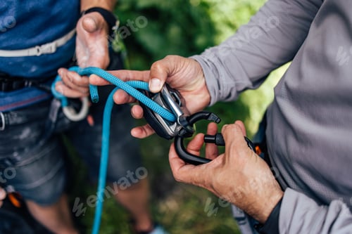 Preview: Close-Up of Climbers Handling Rope and Carabiner Outdoor