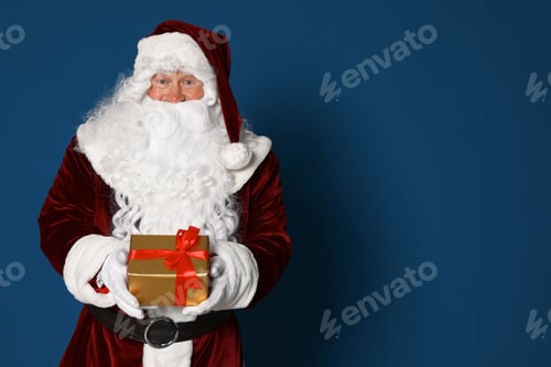 Preview: Authentic Santa Claus with gift box on blue background. Space for text