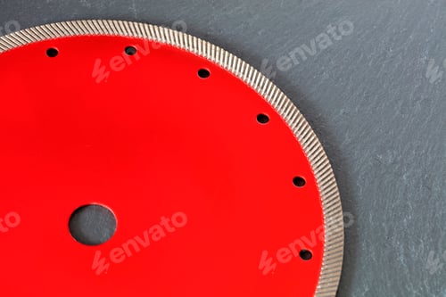 Preview: Part of a diamond cutting blade on a gray granite background.