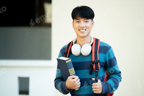 Preview: Portrait of male college student at campus looking at camera.