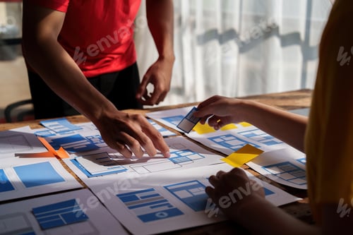 Preview: Group of ux developer and ui designer brainstorming about app interface design at modern office