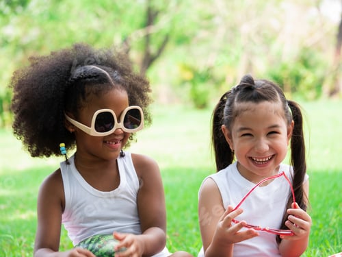 Preview: Two little girls of various ethnic playing together in park