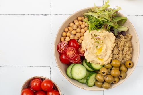 Preview: Top view of colorful Buddha bowl with quinoa, hummus, chickpeas, vegetables. Healthy vegetarian dish