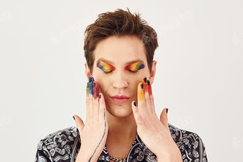 Preview: Young gay man is standing in the studio and posing for a camera