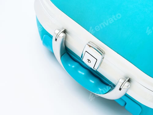 Preview: Closeup of blue suitcase handle on white
