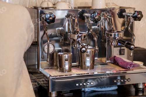 Preview: The barista prepares fresh coffee in the coffee machine in the morning