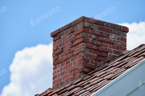 Red Brick Chimney Against a Blue Sky