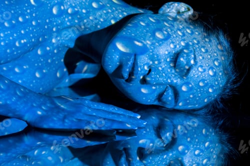 Preview: The Body And Face Of Nude Woman With Blue Pattern From Water Drops And Its Reflection. The Photo