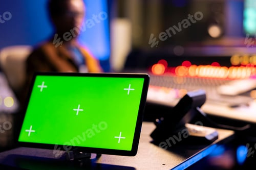 Preview: African american audio technician editing tracks next to isolated display on tablet