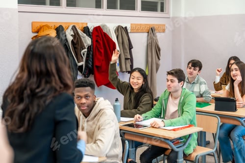 Preview: High school student raising hand in classroom during lesson