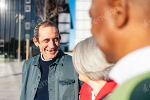 Preview: Elderly companions laughing together on urban street backdrop