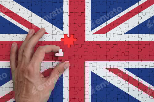 Preview: Great britain flag is depicted on a puzzle, which the man's hand completes to fold.