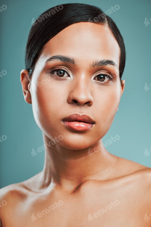 Preview: Portrait of a young beautiful mixed race woman with smooth soft skin posing against a green studio